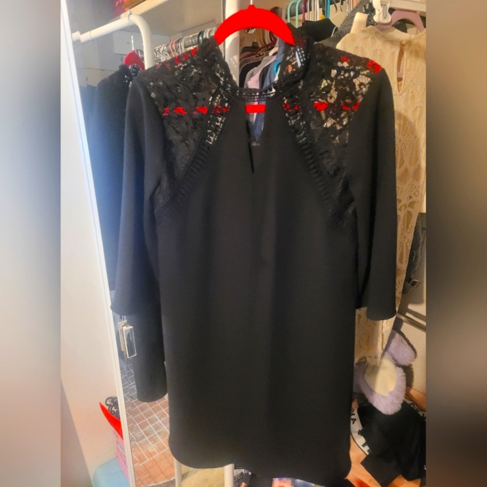 Black lace dress with flowy sleves. Lace top & button neck for perfect fit.